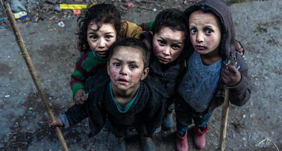 Sick looking children in slum setting with sanitation issues